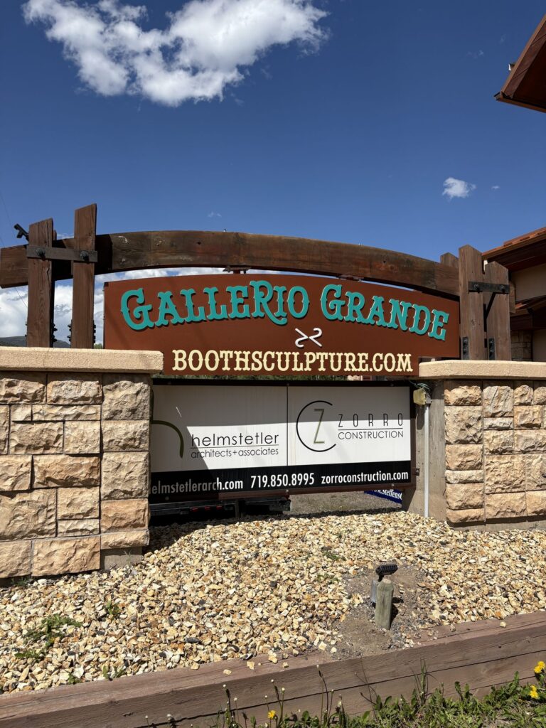 Gallerio Grande and boothsculpture.com dimensional letters on a rust-finish sign panel