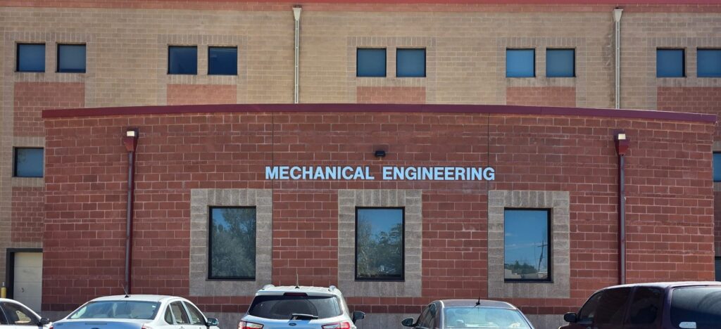 Dimensional "Mechanical Engineering" letters installed on a brick building
