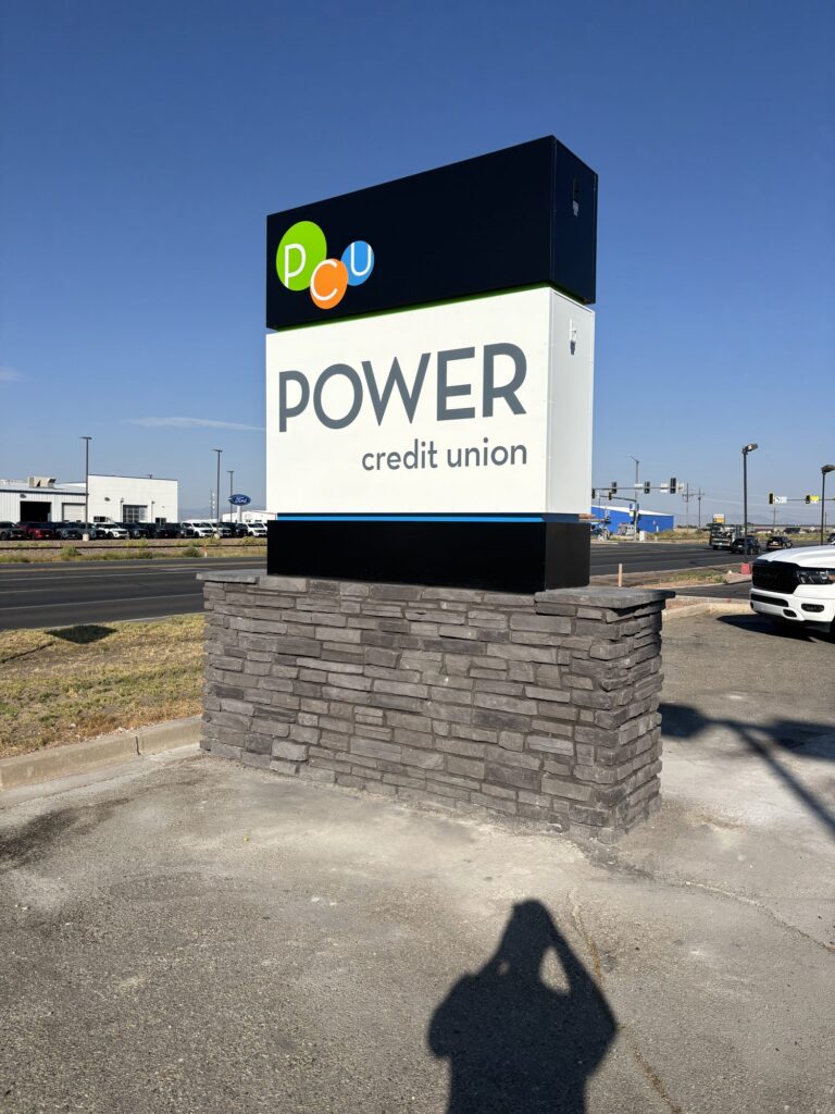 Power Credit Union monument sign on a stacked-stone base
