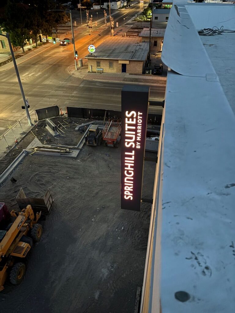 Lighted vertical blade sign for SpringHill Suites by Marriott at night